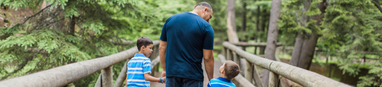 Father walking with sons on a trail
