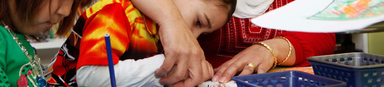 Child care worker and children doing crafts