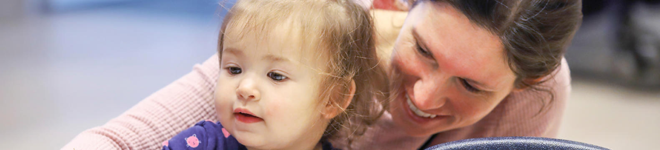 Child care worker and an infant.