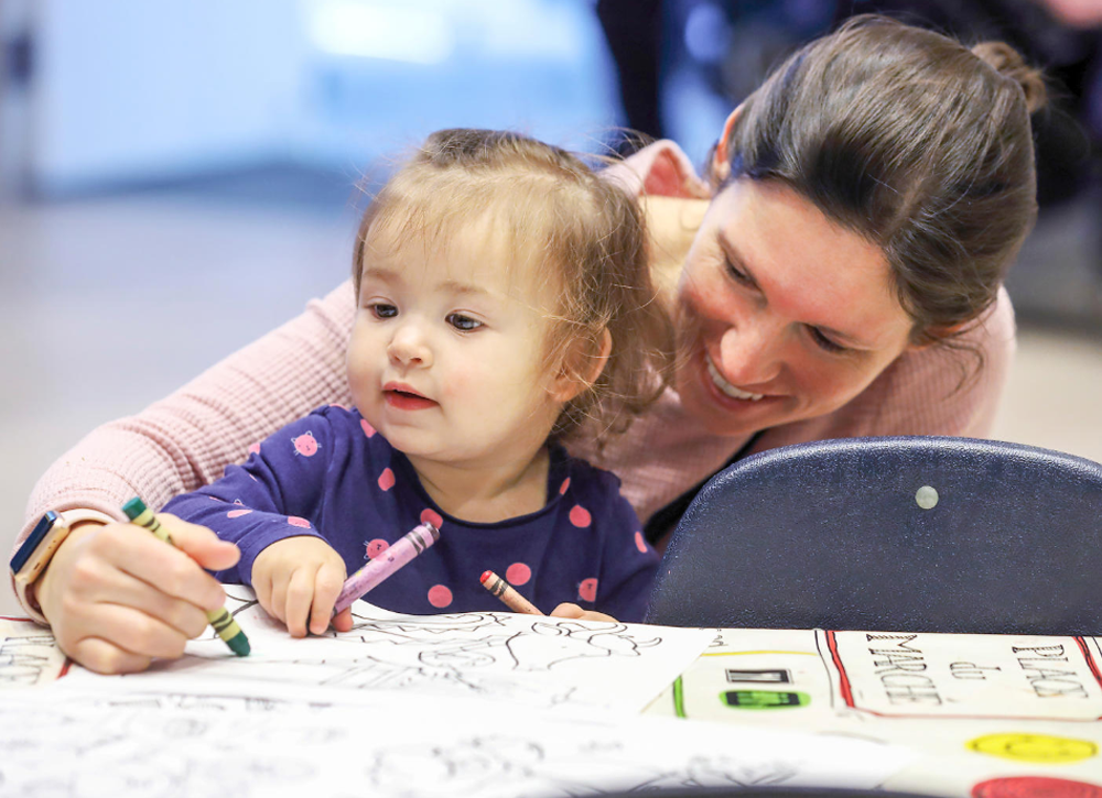 Child care worker and an infant.