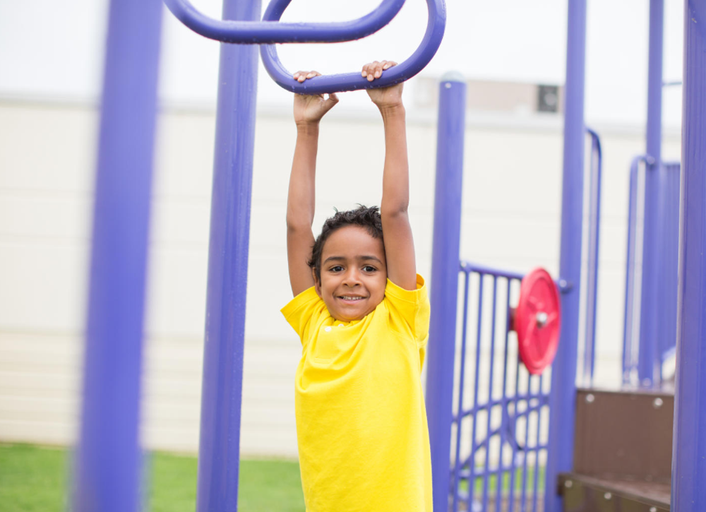 Little boy on a jungle gym