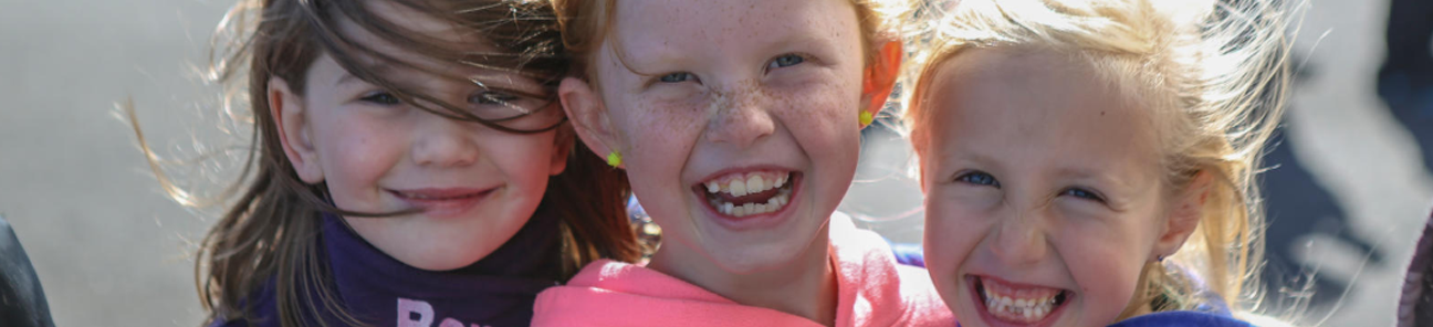 Three young girls laughing