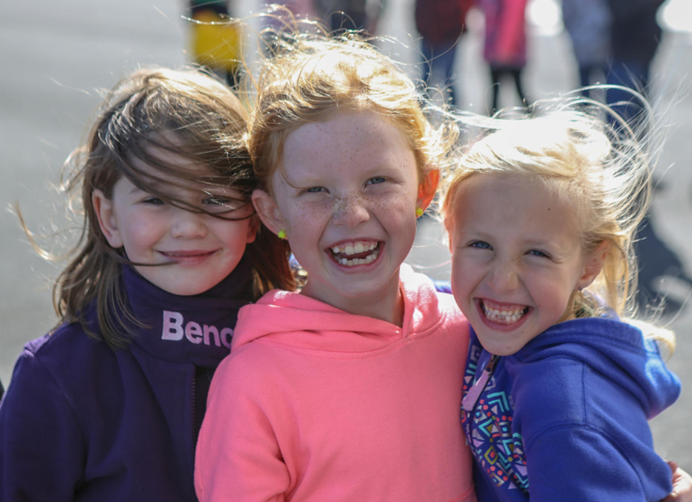 Three young girls laughing