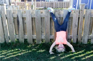 Little girl doing somersaults.